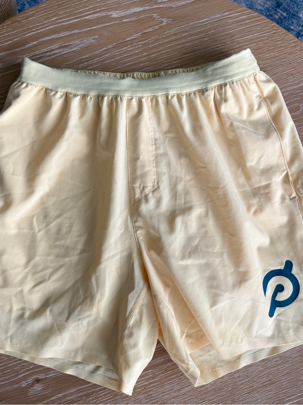 Peloton Pale Yellow Athletic Shorts with Blue Logo